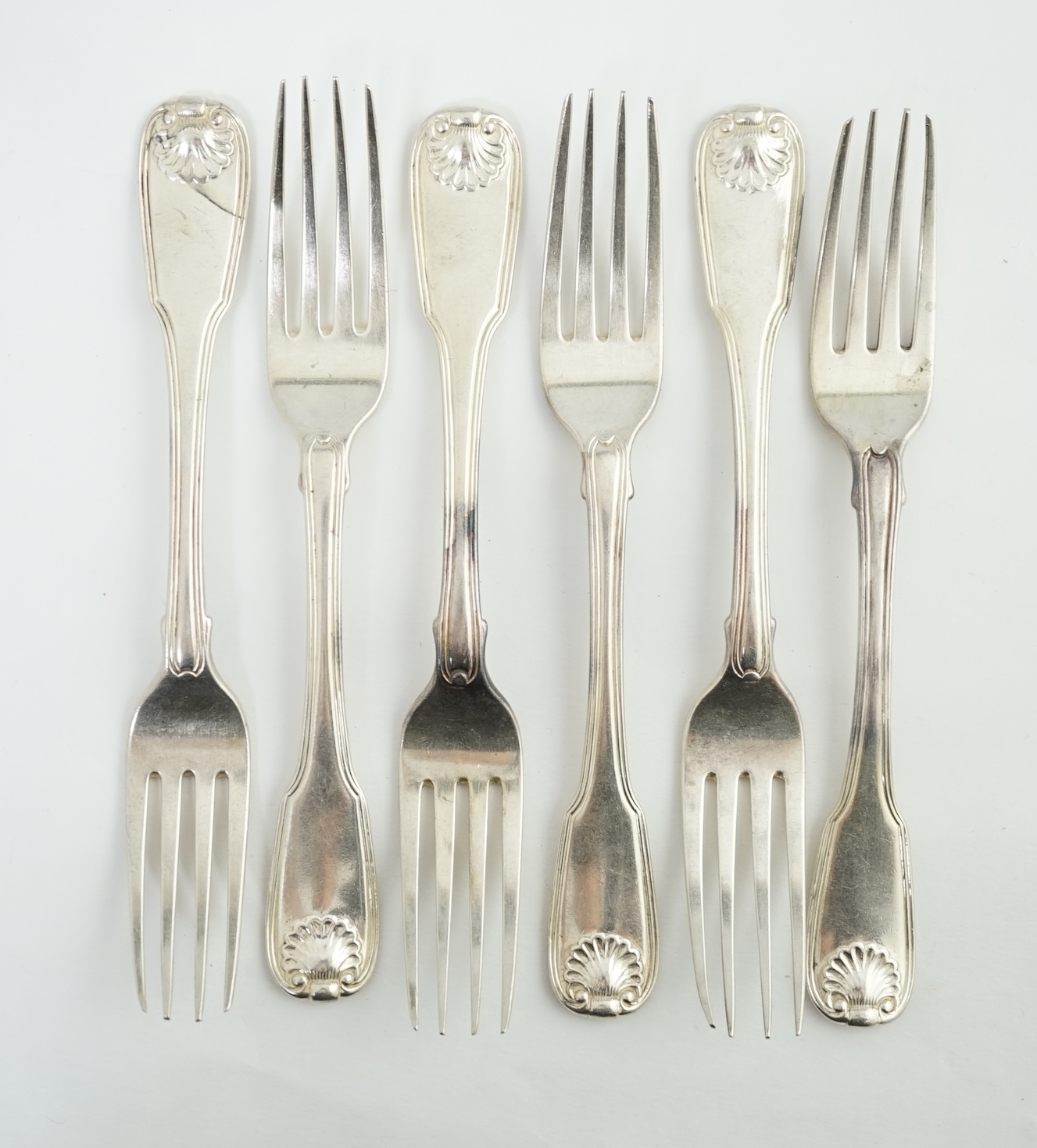 A set of six George III silver fiddle, thread and shell pattern table forks, by William Eley and William Fearn